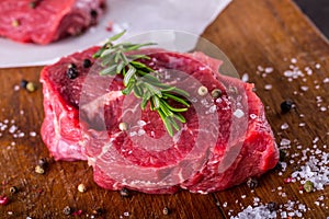 Steak. Raw beef steak. Fresh raw Sirloin beef steak sliced o Herb - Rosemary decoration