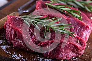 Steak. Raw beef steak. Fresh raw Sirloin beef steak sliced o Herb - Rosemary decoration