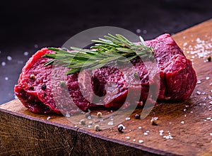 Steak. Raw beef steak. Fresh raw Sirloin beef steak sliced o Herb - Rosemary decoration