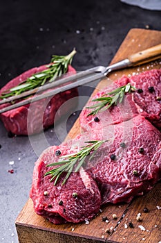 Steak. Raw beef steak. Fresh raw Sirloin beef steak sliced o Herb - Rosemary decoration