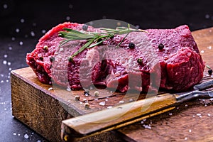 Steak. Raw beef steak. Fresh raw Sirloin beef steak sliced o Herb - Rosemary decoration