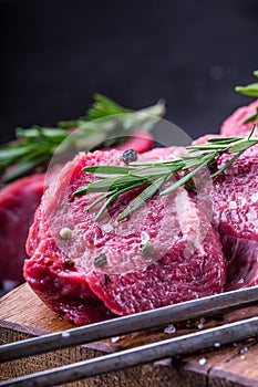 Steak. Raw beef steak. Fresh raw Sirloin beef steak sliced o Herb - Rosemary decoration