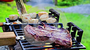 Steak and Scallops grilling on a hibachi on a summer night