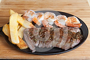 Steak shrimps french fries skillet photo