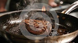 A steak sizzling in a hot frying pan, searing and browning as it cooks photo