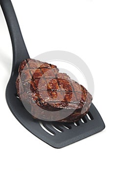 Steak on spatula photo