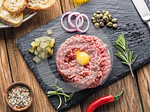 Steak tartare served with raw quail egg yolk and other tartare ingredient. Meat dish