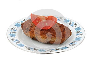 Steak with tomato on a patterned plate