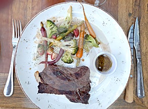 Steak topped with  fresh vegetables