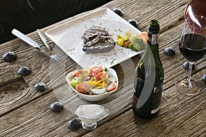 Steak and vegetables on wooden table