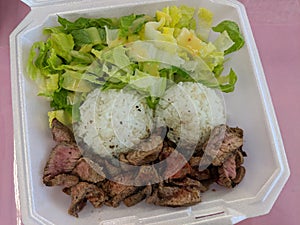 Steak, White Rice, toss salad in a styrofoam plate