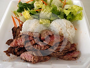 Steak, White Rice, toss salad in a styrofoam plate