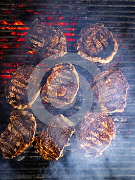 Steaks are generously covered in seasoning