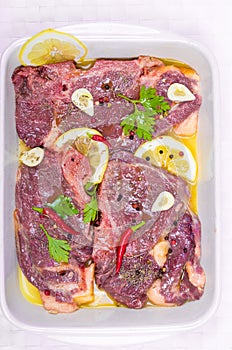 Steaks of red meat , marinated with emulsion of lemon juice and