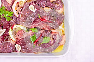 Steaks of red meat , marinated with emulsion of lemon juice and