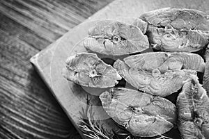 Steaks of red smoked salmon fish and fresh dill, black and white frame