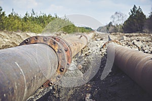 Steal big pipeline on a ground. Old pipes joint.