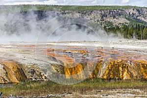 Steam above colorful stones in Yellowstone
