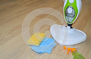 Steam cleaner mop cleaining floor. Cleaning service concept.