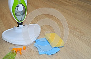 Steam cleaner mop cleaining floor. Cleaning service concept.