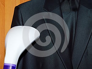 Steam cleaning a suit in laundry