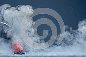 Steam close-up. Steam carpet cleaning on blue background. Home cleaning. Photo with copy space