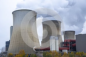 Steam clouds rising from cooling towers of power station.