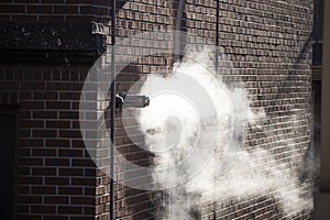 Steam coming out of a central heating flue on a house wall in South Korea