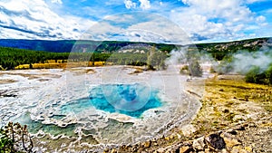 Steam coming from the turquoise waters of the Artemisia Geyser hot spring in the Upper Geyser Basin in Yellowstone National Park