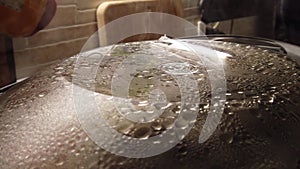 steam cooking close up background in loop . steam comes out copious from the lid of the steamer full of droplets