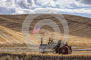 Steam engine and flag in field.