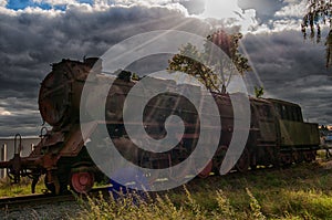 Steam engine on the railways on sun rays