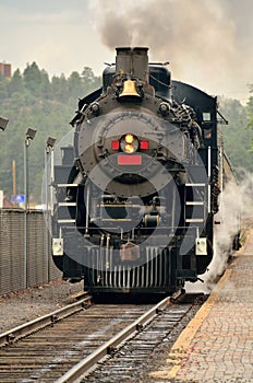 Steam engine at a train station