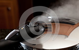 Steam escaping from new pressure cooker pot photo