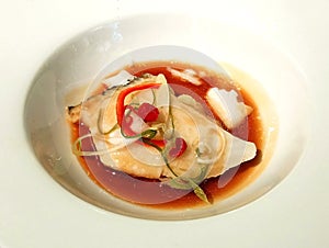 Steam fish with sauce on white bowl