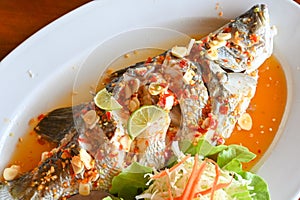 Steamed fish with lime - Thai food photo