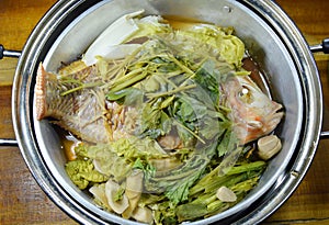 Steam fish and vegetable in stainless steamer pot