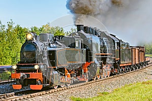 Steam freight train departs from the railway station