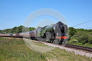 Steam locomotive 60163 Tornado pulling a train on the Swanage Heritage railway in Dorset, England, UK