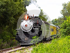 Steam locomotive barreling down the tracks