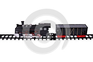 A steam locomotive and a car on the rails. Toy train on a white background, isolated image