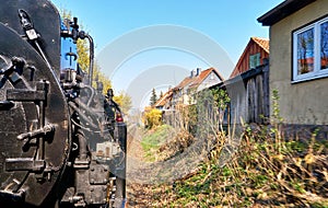 Steam locomotive drives past the houses in Wernigerode. Dynamic due to motion blur