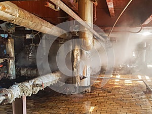 Steam from the pipe. under pressure in production. factory breakdown. gas leak. Leakage of steam in heat pipeline interior