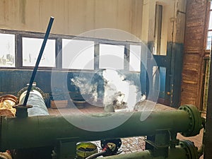 steam from the pipe. under pressure in production. factory breakdown. gas leak. Leakage of steam in heat pipeline interior