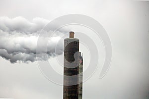 Steam and polluting smoke rises from the chimney of waste incinerator AEB in Amsterdam photo