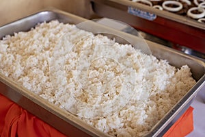 Steam rice served for buffet, catering service on celebration. Steamed rice in pan closeup. Traditional asian food photo