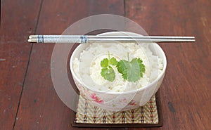 Steam rice in white bowl with chopstic