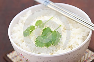 Steam rice in white bowl with chopstic