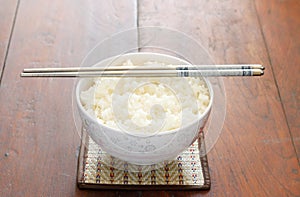 Steam rice in white bowl with chopstic