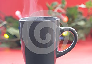 Steam rising from a cup of coffee or tea with a bokeh effect and golden leaves